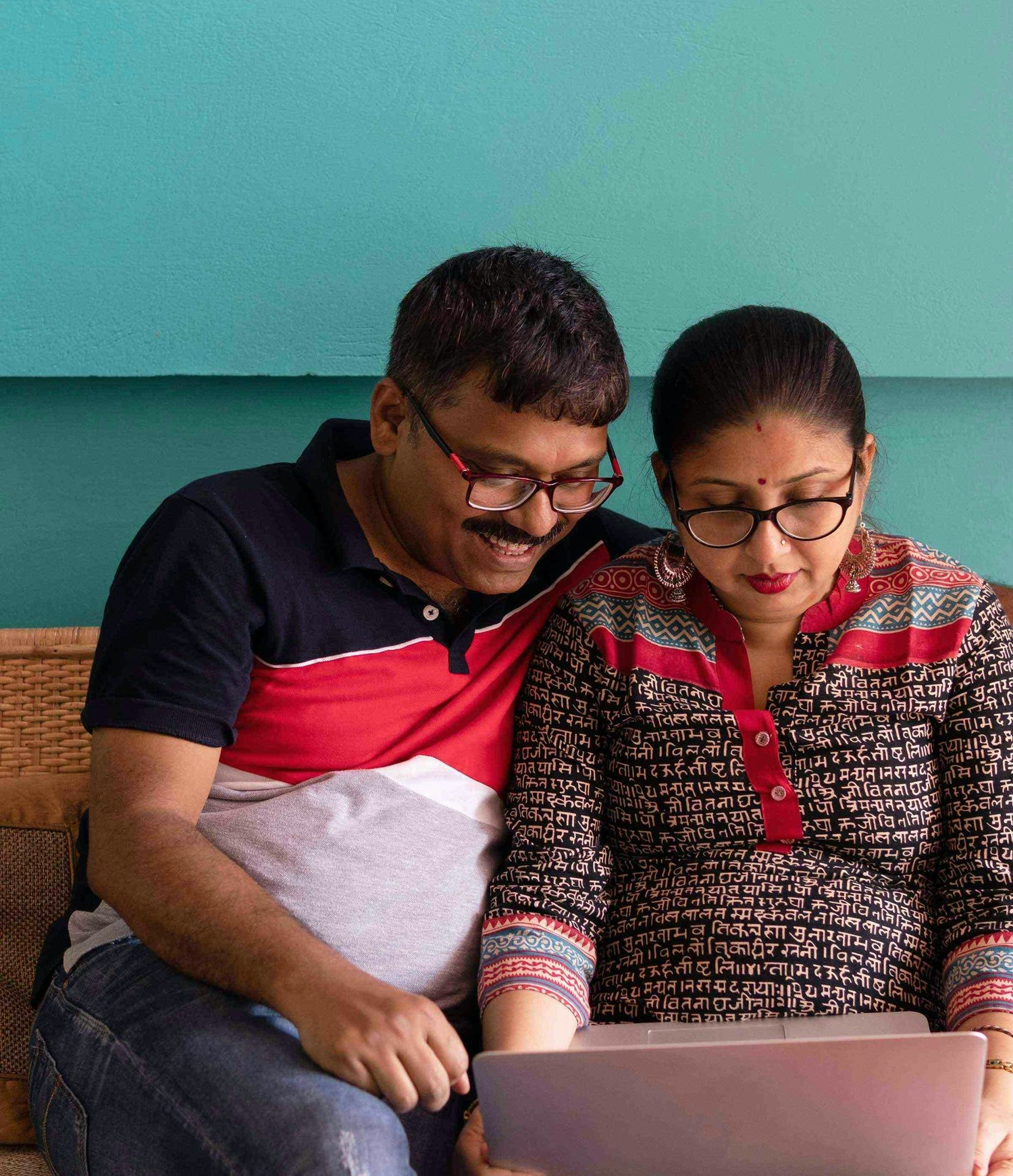 Couple in New Delhi, India looking at computer together